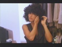 Trashy unknown italian 80's movie but a nice scene. Girl is putting on a culy wig and adjusting it.