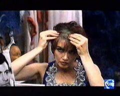 Milly Carlucci wearing dark and blonde wigs in movie "Tiempos mejores" (1994). She is disliked by her husband and tries her luck as a prostitude. To cover her hairloss and since she does not want her friends and neighbours to get aware of her new job she wears a wig. The new job runs with minor effort, so she finally throws away the wig and covers her mirror with a blanket because she could not beware to see her image no longer.